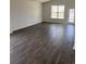 Spacious living room with hardwood floors, large windows, and a bright, open feel at 905 Inlet Keys St., Murrells Inlet, SC 29576