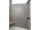 Shower with gray tiling, a built in bench, and rainfall shower head at 905 Inlet Keys St., Murrells Inlet, SC 29576