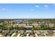 Aerial view of 9060 Abingdon Dr surrounded by mature trees, lush landscaping, and a serene lake nearby at 9060 Abingdon Dr., Myrtle Beach, SC 29579