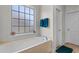 Bathroom features large soaking tub, window, and neutral colors at 9060 Abingdon Dr., Myrtle Beach, SC 29579