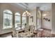 Dining area with natural light, hardwood floors, complemented by the arched windows and decorative chandelier at 9060 Abingdon Dr., Myrtle Beach, SC 29579