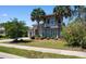 Charming home with lush landscaping, palm trees, and a well-manicured lawn creating a picturesque curb appeal at 9060 Abingdon Dr., Myrtle Beach, SC 29579