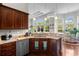 A well-equipped kitchen with wooden cabinets, granite countertops, stainless steel appliances, and an adjacent dining area at 9060 Abingdon Dr., Myrtle Beach, SC 29579