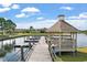 Picturesque view of a gazebo on a pier overlooking the lake, perfect for relaxation and enjoying the natural beauty at 9060 Abingdon Dr., Myrtle Beach, SC 29579