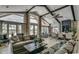 Spacious living room featuring vaulted ceilings, exposed beams, large windows, and modern decor at 9060 Abingdon Dr., Myrtle Beach, SC 29579