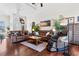 Living room showcasing hardwood floors, comfortable seating, and lush indoor plants with an adjacent massage chair at 9060 Abingdon Dr., Myrtle Beach, SC 29579