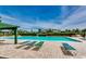 Relaxing poolside view with lounge chairs and clear blue water, surrounded by lush landscaping at 9060 Abingdon Dr., Myrtle Beach, SC 29579