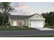 Charming single-story home features a two-car garage, manicured lawn, and welcoming curb appeal at 907 Inlet Keys St., Murrells Inlet, SC 29576