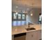 Open-concept kitchen view to living room with modern pendant lighting at 907 Inlet Keys St., Murrells Inlet, SC 29576
