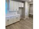Kitchen with white cabinets, subway tile backsplash, quartz countertops, and wood flooring at 907 Inlet Keys St., Murrells Inlet, SC 29576