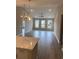 Spacious living room featuring hardwood floors, large windows, and modern light fixtures at 907 Inlet Keys St., Murrells Inlet, SC 29576