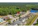 Expansive aerial showcasing a charming neighborhood with a tranquil pond, enveloped by verdant trees and lush greenery at 908 Oglethorpe Dr., Conway, SC 29527