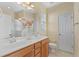 Bathroom featuring dual sinks, vanity, large mirror, and bright lighting at 908 Oglethorpe Dr., Conway, SC 29527