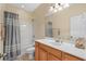 Bathroom with a white counter, wood cabinets, and a shower with a gray curtain at 908 Oglethorpe Dr., Conway, SC 29527