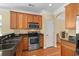 Close up of the kitchen with stainless steel appliances, granite countertops, and wood cabinets at 908 Oglethorpe Dr., Conway, SC 29527