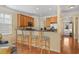 Charming kitchen bar with wood cabinets and seating, open to the home's entry door at 908 Oglethorpe Dr., Conway, SC 29527
