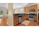 Well-lit kitchen features wood cabinets, stainless steel appliances, and a practical layout at 908 Oglethorpe Dr., Conway, SC 29527
