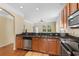 Galley kitchen with stainless appliances, wood cabinets, granite countertops and access to the living space at 908 Oglethorpe Dr., Conway, SC 29527