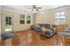 Cozy living room with hardwood floors, a comfortable gray sofa, and plenty of natural light at 908 Oglethorpe Dr., Conway, SC 29527