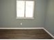 This bedroom has durable floors, a window and soothing green walls at 950 Forestbrook Rd. # C3, Myrtle Beach, SC 29579