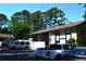 View of a two-story condo building with balconies, gray siding, and well-maintained parking lot at 950 Forestbrook Rd. # C3, Myrtle Beach, SC 29579
