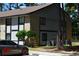 Two-story condo building featuring a light gray and brick facade, set among mature trees at 950 Forestbrook Rd. # C3, Myrtle Beach, SC 29579