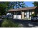 A two-story condo building with a brick and light gray facade and black trim, complemented by parking spots in front at 950 Forestbrook Rd. # C3, Myrtle Beach, SC 29579