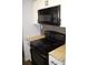 Kitchen features white cabinets, granite countertops, black microwave and a range oven at 950 Forestbrook Rd. # C3, Myrtle Beach, SC 29579