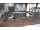 Indoor hot tub with brick surround, metal access railing, and safety signage at 9550 Shore Dr. # 1728, Myrtle Beach, SC 29572