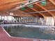 Large indoor pool with a vaulted wood ceiling and ample seating for relaxing and lounging at 9550 Shore Dr. # 1728, Myrtle Beach, SC 29572
