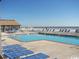 Community outdoor swimming pool with plenty of lounge chairs and an ocean view at 9550 Shore Dr. # 1728, Myrtle Beach, SC 29572