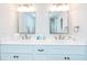 Bathroom features a white double vanity, framed mirrors, and modern faucets at 9820 Queensway Blvd. # 401, Myrtle Beach, SC 29572