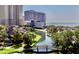 Scenic view of the waterway and buildings in the complex, with trees and a charming wooden bridge at 9840 Queensway Blvd. # 1819, Myrtle Beach, SC 29572