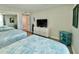 Bedroom featuring two beds with patterned quilts, dresser with tv, and ocean themed decorations at 9840 Queensway Blvd. # 1819, Myrtle Beach, SC 29572