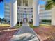 Inviting entrance to the building with manicured landscaping and a well-maintained walkway at 9840 Queensway Blvd. # 1819, Myrtle Beach, SC 29572