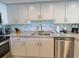 Modern kitchen featuring stainless steel appliances, granite countertops, and white cabinets at 9840 Queensway Blvd. # 1819, Myrtle Beach, SC 29572