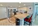 Well-lit kitchen featuring stainless steel appliances, light cabinets, granite countertops, and a breakfast bar at 9840 Queensway Blvd. # 1819, Myrtle Beach, SC 29572