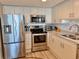 Bright kitchen with stainless steel appliances, granite countertops, and white cabinets at 9840 Queensway Blvd. # 1819, Myrtle Beach, SC 29572