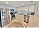 Modern kitchen with stainless steel appliances, granite countertops, and bright, white cabinets at 9840 Queensway Blvd. # 1819, Myrtle Beach, SC 29572