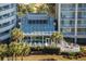 An aerial view of a luxurious indoor pool area surrounded by lush greenery and palm trees, and outdoor seating at 9840 Queensway Blvd. # 1819, Myrtle Beach, SC 29572