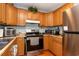 Efficient kitchen with stainless steel appliances, wood cabinetry, and a practical layout at 1015 Elm St. # 18, Conway, SC 29526