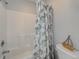 Close-up of a bathtub with showerhead and a floral patterned shower curtain at 104-4 Gully Branch Ln. # 4, Myrtle Beach, SC 29572