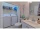 Bright bathroom featuring a vanity, toilet, and closet that includes washer and dryer units at 104-4 Gully Branch Ln. # 4, Myrtle Beach, SC 29572