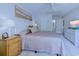 Cozy bedroom featuring a painting above the headboard and an open door to the bathroom at 104-4 Gully Branch Ln. # 4, Myrtle Beach, SC 29572