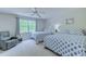 Bright bedroom featuring two twin beds with blue patterned bedding, a ceiling fan, and a comfortable chair at 104-4 Gully Branch Ln. # 4, Myrtle Beach, SC 29572