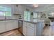 Well-lit kitchen featuring white cabinets, granite countertops, and views of the backyard and lake at 104-4 Gully Branch Ln. # 4, Myrtle Beach, SC 29572