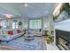 Bright living room with fireplace, ceiling fan, and large window offering picturesque views at 104-4 Gully Branch Ln. # 4, Myrtle Beach, SC 29572