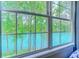 Beautiful window view showcasing a tranquil lake surrounded by lush green trees at 104-4 Gully Branch Ln. # 4, Myrtle Beach, SC 29572