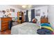 A cozy bedroom featuring hardwood floors, a ceiling fan, and natural light, offering a tranquil space at 106 Azalea Dr., Conway, SC 29526