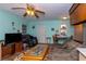 Cozy living room with a ceiling fan, comfortable seating, and a dining table area, offering versatile living space at 106 Azalea Dr., Conway, SC 29526